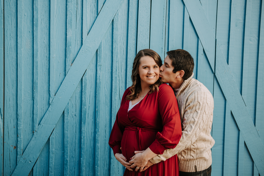 Author and her husband pose for maternity photo